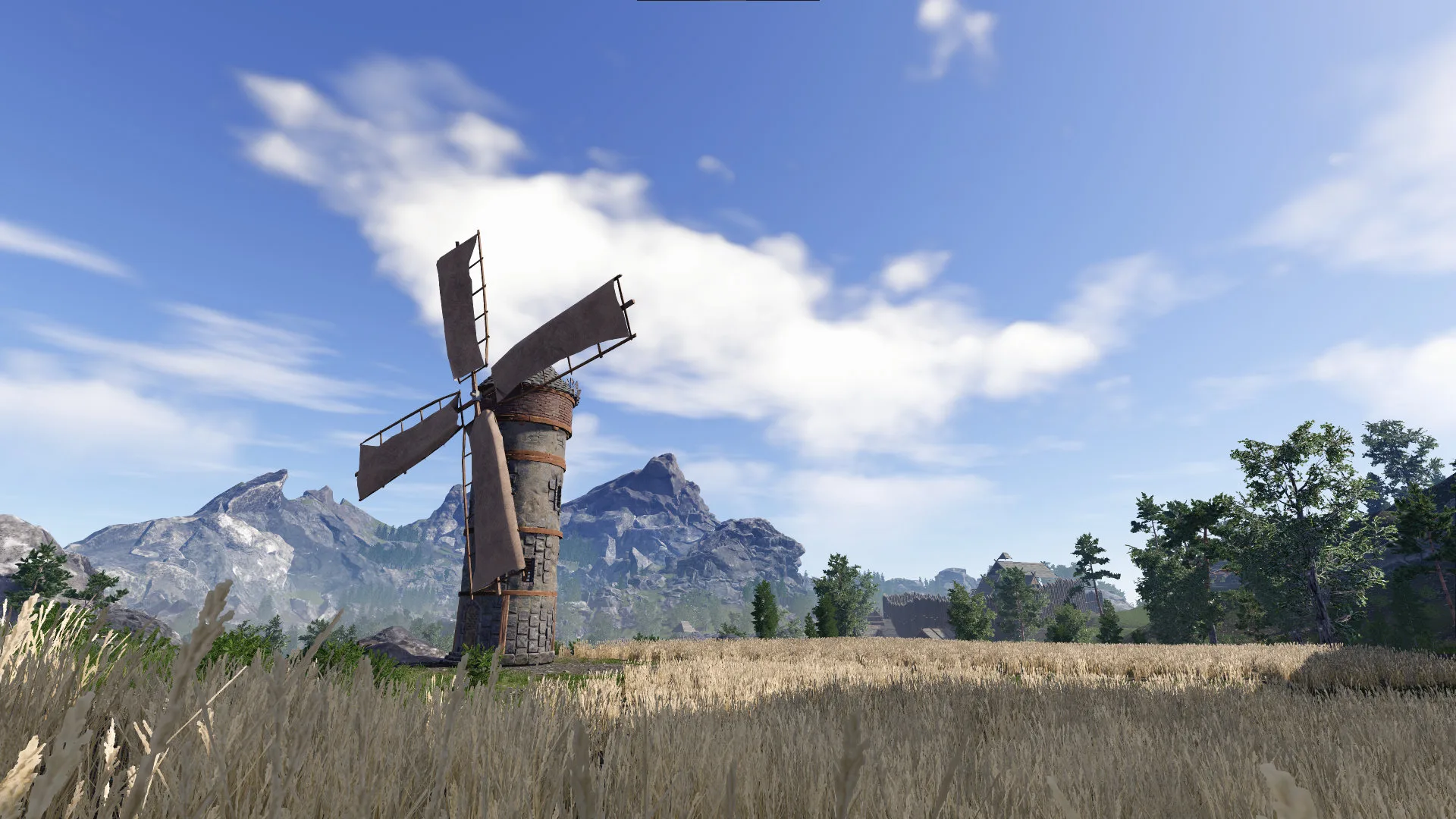 A windmill on a grassy field under a clear sky
